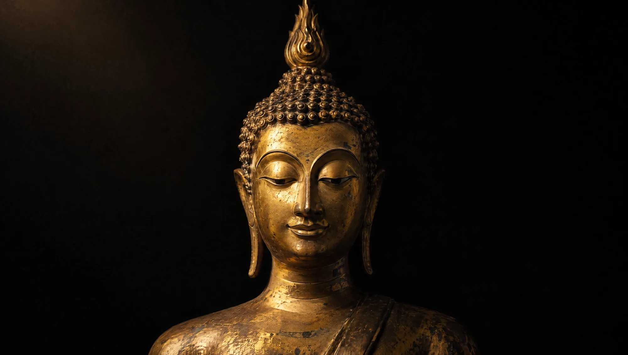 A Thai Sukhothai-style Buddha in polished gold bronze with a flame finial