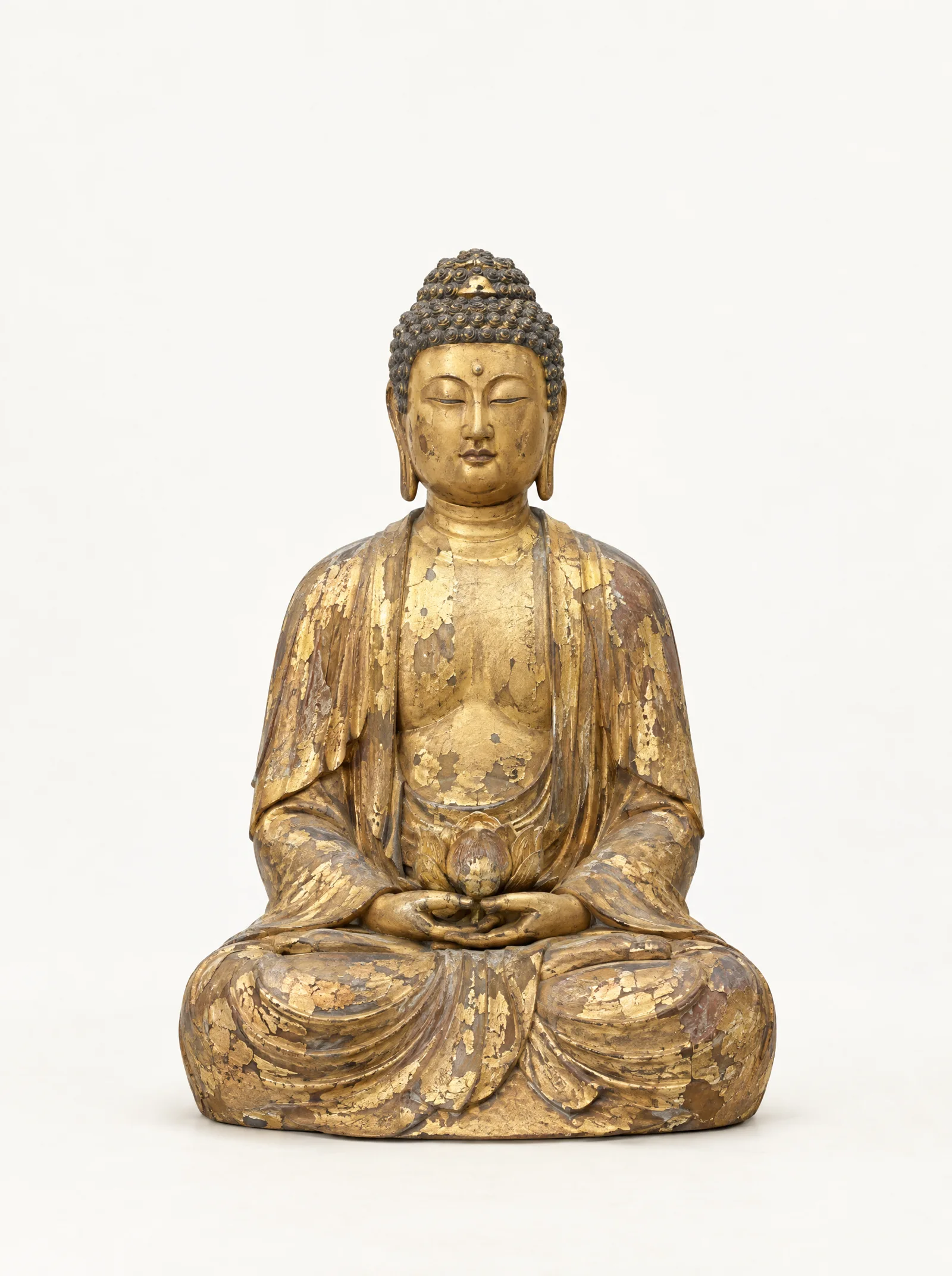 A seated Amitabha Buddha in gilded wood with flaking gold leaf