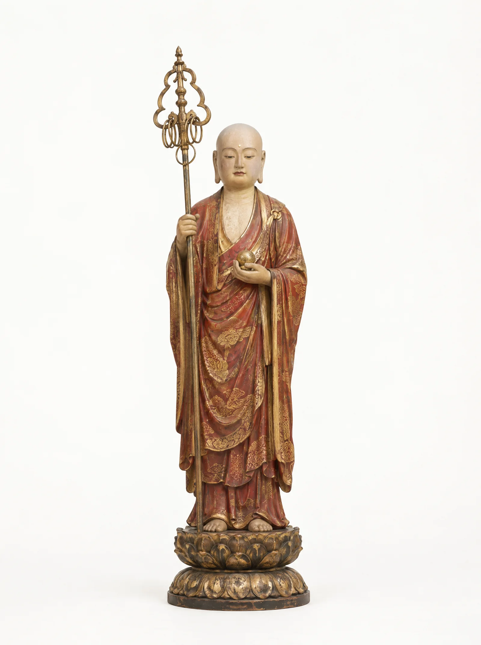 A standing Ksitigarbha as a monk in red and gold robes holding a ringed staff